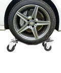 Whopping 6000 Lb Capacity Car Wheel Dollies Set Of 4 Heavy Duty Steel With Locking Brakes under a car tire on 3 inch swivel casters.