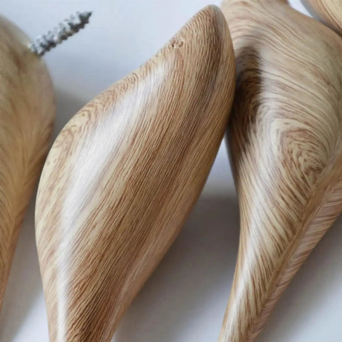 Close-up of the Straight Up Best Bird Shaped Resin Wall Hook With Wood Grain Finish, showing smooth curved edges and texture.