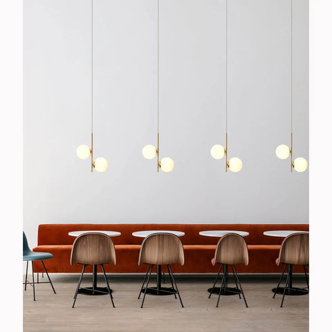 Dope 2 Light Globe Pendant Lighting With White Glass Shades And Brass Gold Metal Accents over dining area