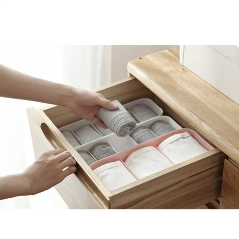Four Piece Plastic Drawer Organizer Box With Compartment Dividers For Bras Underwear And Socks Nifty Closet Storage Bins organized with socks and underwear in a wooden drawer.