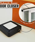 Automatic Retractable Door Closer Set Two Pack, Black ABS Plastic with cable, shown installed on white door