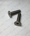 Titanium Gr2 Hex Socket Countersunk Screws Metric M2 Through M8 Din7991 Flat Head Bolts on textured background.