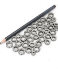 Premium Stainless Steel Deep Groove Ball Bearings Miniature Smr63zz arranged next to a pencil, showcasing size and quality.