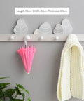 Slick Solid Wood Wall Mount Coat Rack And Key Holder With Smooth Finished Hooks for hanging a pink umbrella and cozy white scarf.