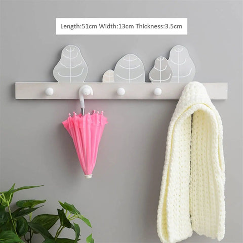 Wall Mounted Rustic Wood Coat Rack With Dope Key Storage Hooks Keeps Your Gear Neat, displays a pink umbrella and white scarf.