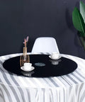 Heavy Hitter Black Glass Lazy Susan With Slick Swivel Action For Dining Tables And Potluck Spread Featuring Heat Resistant Face And Grippy Anti Skid Bottom For No Fuss Hospitality Service on a dining table.