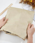 Hands holding Replacement Canopy For Outdoor Swing 77x50 Inch Beige Oxford Cloth Roof Cover UV Weatherproof Waterproof