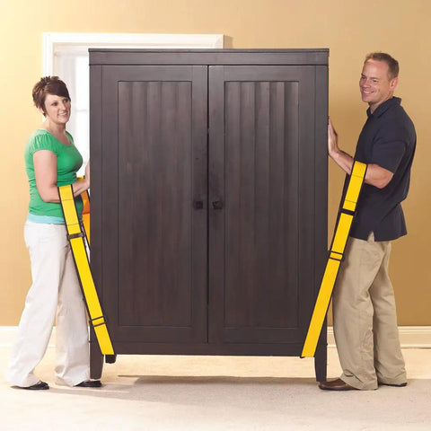 Couple using Badass Forearm Moving Straps that take the heavy load off you while moving a large wooden cabinet.