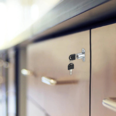 Heavy Duty Push Plunger Lock With Keys Plus Screws And Lock Rings For Drawers And Cabinets featuring a silver cylinder lock on a drawer.