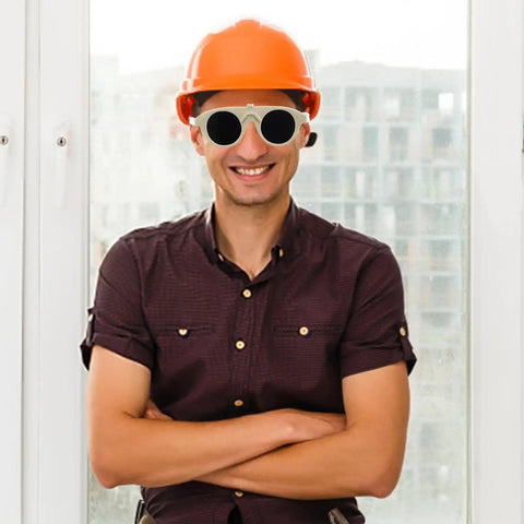 High Grade Welding Goggles And Safety Glasses Featuring Adjustable Impact Resistant Lenses For Gas Arc Cutting Grinding Hardcore Shop Job Crew Approved Must Have Gear worn by a man with orange hard hat, smiling, arms crossed.