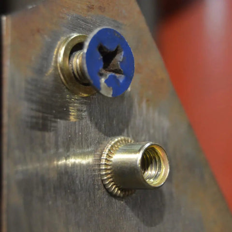 Close-up of a carbon steel threaded rivet nut insert in use from Rivet Nut Inserts Kit Pro Grade 500 Pcs Carbon Steel Threaded Nut Inserts