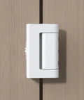 White Adjustable Portable Door Lock Rock Solid Security Reinforcement For Hotels Dorms Lock Down Your Room Bail Proof Tuff Travel Gear For Apartment Safe Setup mounted on a wooden door.