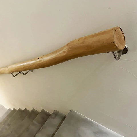 Built Like A Tank Adjustable Solid Wood Handrail Kit Tough Metal Brackets Nonslip Stair Railing mounted on wall near stairs.