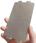 Hand holding a mica sheet, part of Five Pack Waveguide Covers For Microwave Ovens Mica Sheet Replacement Part Universal Microwave Repair Shield Helps Protect Magnetron From Splashes Ideal For Home Kitchen Office And Restaurant Use Two And A Quarter Inch By Four And Five Eighths Inch