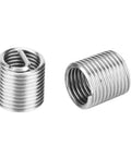 Two stainless steel threaded inserts from M7x1 Thread Repair Kit 25 Piece With Twisted Drill Tap Wrench Breaker Hex Wrench And 20 Stainless Steel Threaded Inserts For Easy Hole Repair In Auto Industrial Gear And Electronics DIY Friendly.