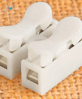 Solid VCM Bypass Harness And Resistor Plug Set For 3.5L V6 Engine showing white connector plugs on textured background.