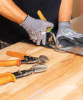 Person using Left-Cutting Offset Tin Snips For Sheet Metal on a metal sheet, showing heavy-duty steel construction and spring-action lock.