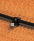 Close-up of Patio Drip Irrigation Kit With Faucet Connection, 42-Piece Set, black one quarter inch tubing fixed on wood surface