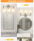 Three Light Bathroom Vanity Light Fixture In Brushed Nickel With Clear Glass Shades Over Mirror Wall Sconce No Fuss Easy To Install