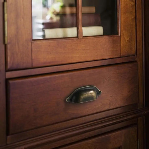 Vintage Half Moon Cup Pulls 30 Pack Pressed Steel Cabinet Handles on wooden drawer with rustic finish.