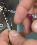 Close-up of hands using 50 Pieces M4x25 Black Aluminum Round Head Blind Rivets With Large Flange in a lock mechanism
