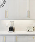 Modern kitchen with white cabinets featuring 10 Pack Brushed Brass Knurled Cabinet Handles 5 Inch Center to Center, gold-toned pulls installed.