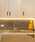 Modern kitchen with white cabinets featuring 30 Pack 5 Inch Matte Black Cabinet Pulls With Round Base For Kitchen Cabinets And Drawer Fronts.