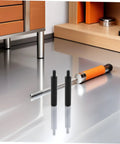 Smooth As Butter Soft Close Dampers 6 Pack Hydraulic Buffer Inserts For Drawers on a reflective surface with a metallic tool.