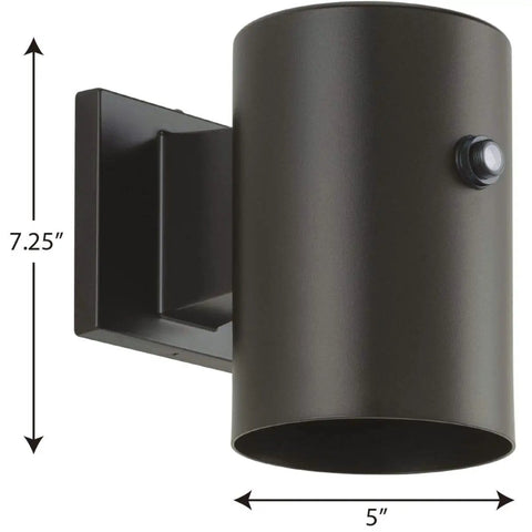 Slick Modern Cylindrical LED Outdoor Wall Lantern In Antique Bronze Featuring Smooth Minimalist Lines And Top Shelf Glow Designed For Covered Patios Decks Porches And Garages Seeking A Straight Up Style Upgrade, 5"x7.25".