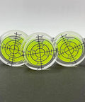 Six Piece Compact Circular Bubble Spirit Level Kit For Your Rig And Camper 32mm standard gauge trio of acrylic levels on dark background.