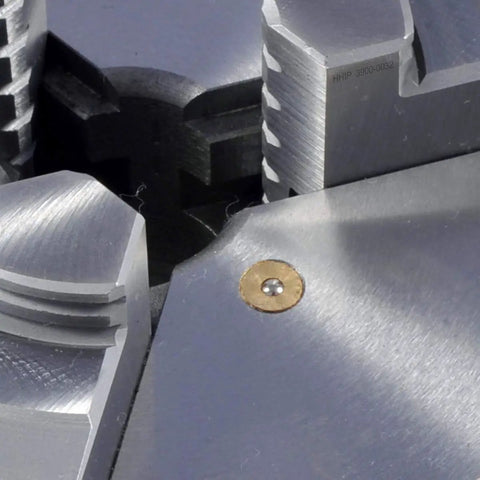 Close-up of a 4 Inch 3-Jaw Lathe Chuck Plain Back Hardened Semi-Steel With Wrench Includes 2 Sets Of Hardened Jaws Internal And External