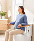 Adjustable Height Toilet Safety Rails For Seniors Boasting Top Shelf Handholds, shown in use by a pregnant woman for support.
