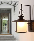 Rock Solid Outdoor Wall Lantern With Thick Frosted Glass Shade And E27 Socket Waterproof Rust Proof Aluminum Sconce For Porches And Patios Effortlessly Boosting Your Curb Appeal With Smooth Even Lighting mounted beside a doorway.
