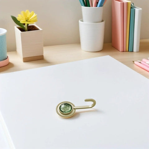 Pack Of 4 Self Adhesive Wall Hooks Featuring A Vintage Diamond Design in green on table with stationery and plants.