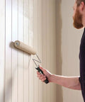 Person painting a wall using R523 18 Inch Microfiber Paint Roller Cover Three Eighths Inch Nap Pack Of 6 for smooth finish and strong paint pickup.