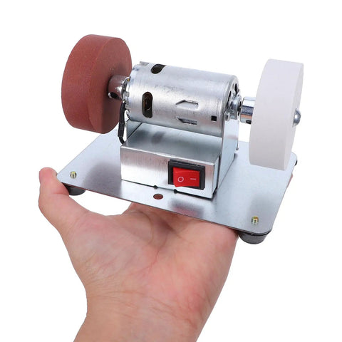Rock Solid Electric Knife Sharpener Stainless Steel Bench Grinder For Kitchen Tools With Non Slip Base And Flexible Angle Matching Desktop Rig For Slick Polish Jobs held in a hand.