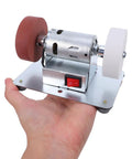 Tough Desktop Belt Sander And Badass Knife Sharpener Featuring Adjustable Grinding Angles Easy Plug-In Design Compact Motorized Finishing Machine held in hand.