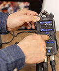 Hustle Ready Podcast Creator Kit Featuring A Sick Four Channel Handheld Recorder with user adjusting settings.