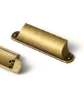 Six Pack Antique Brass Cabinet Cup Pulls Three Inch Center To Center Spacing Built Tough Zinc Alloy Kitchen Drawer Pulls Knockout Vintage Charm Quick Swap Install - Close-up detail of antique brass cup pulls.