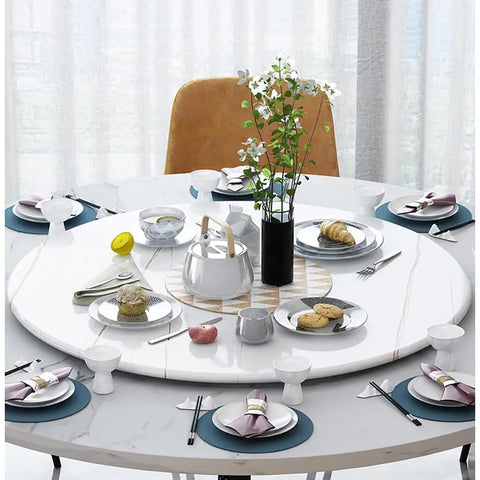 Built Tough 23 Inch Marble Lazy Susan With Butter Smooth 360 Degree Swivel Action And Rock Solid Nonslip Base set on a dining table filled with dishes.