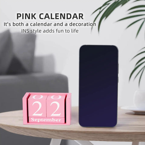 Pink Decor Wooden Desk Calendar Blocks on table, 22 September, cute desk accessory for women with smartphone nearby.