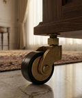 Hella Sturdy Solid Brass Stem Casters With Antique Gold Finish 7MM Slick Swivel Wheels Heavy Duty Rollers on a cabinet leg