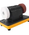 Cordless Mini Bench Grinder With Variable Speed Settings And Twin Grinding Discs side view showing white and brown grinding wheels on a compact base.