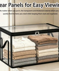 Built Like A Tank Large Clear Plastic Storage Bin With Heavy Duty Foldable Frame Reinforced Handles And A Secure Zippered Lid containing neatly folded clothes.