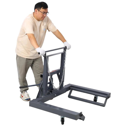 Person using Dual Wheel Truck Dolly With Integrated Jack And 1500 Lb Capacity Adjustable Height for heavy trucks.