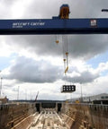 Industrial crane with hoist system over shipping dock, demonstrates use with Hoist Crane Wireless Pro Grade Remote Control Transmitter Kit.