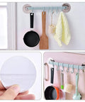 Self Adhesive Bathroom Towel Ring Holder With Rock Solid Grip Pad For Hassle Free Wall Mount Kitchen Storage Rack Stainless Steel Look with kitchen utensils hung.