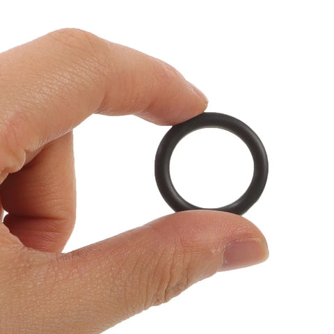 Close-up of a hand holding a black rubber ring from the 50 Piece Electric Wrench Socket Rubber Ring Replacement Kit With Rugged Fastener Pins And Dependable Wrench Holder Washers For No Sweat Rebuilds And Smooth Daily Shop Grind.