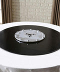 Smooth As Butter Lazy Susan Turntable For Dining Table, black tempered glass base on a white tablecloth surface.
