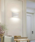 Aluminum Modern LED Wall Sconce Set Of 2 Dope Hardwired Up And Down Wall Mount Lights in living room with cool white glow